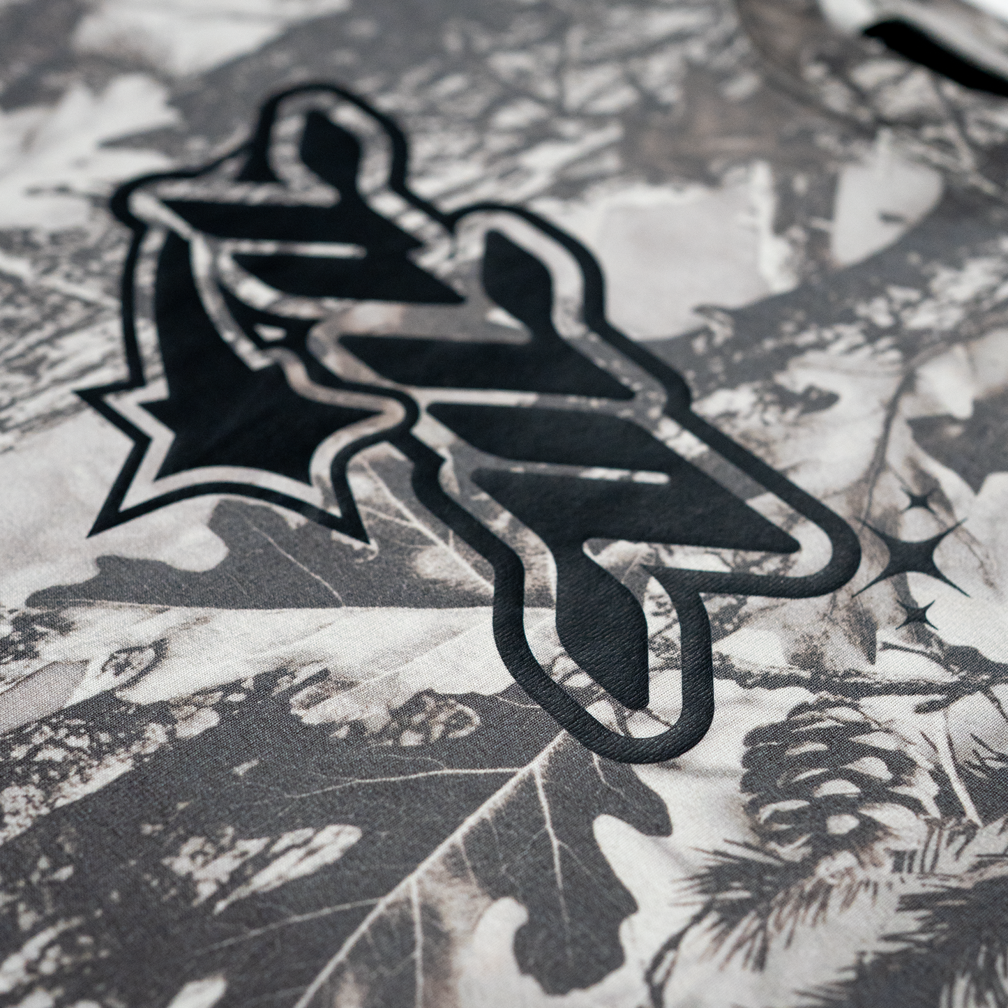 Heavyweight 100% cotton oversized tee featuring an all-over grey woodland camo print and black NTA front graphic. Made with 250 GSM cotton and a drop-shoulder fit.
