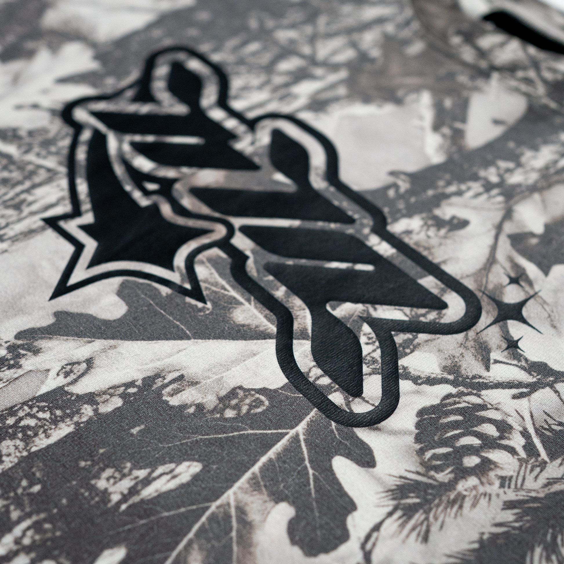 Heavyweight 100% cotton oversized tee featuring an all-over grey woodland camo print and black NTA front graphic. Made with 250 GSM cotton and a drop-shoulder fit.